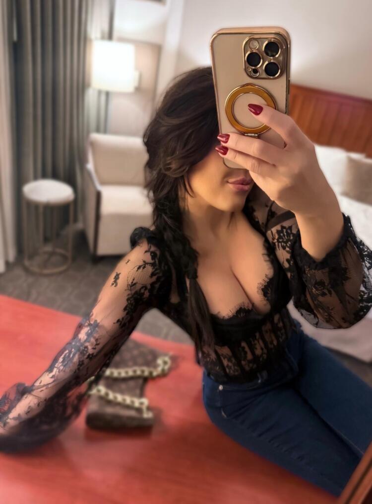 woman seating taking selfies