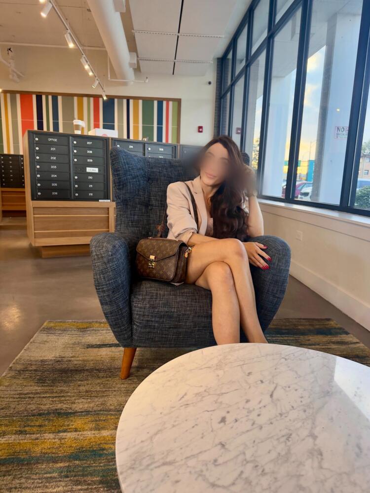 brunette seating playing with hair